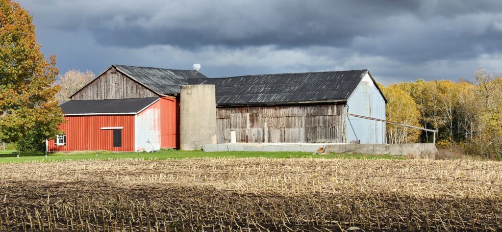 old barn in a field mutiple additions